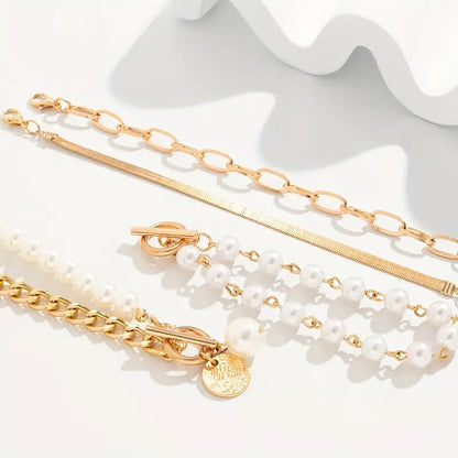 Set de pulseras elegantes de oro (4 piezas) – serpiente, perlas y eslabones.